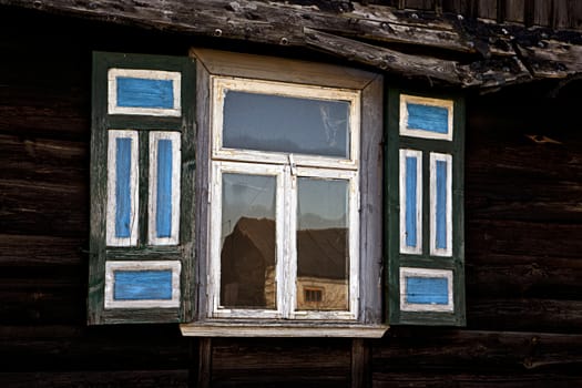 Old window with colourful shutters