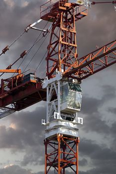 Industrial red crane, sunset background, construction and works