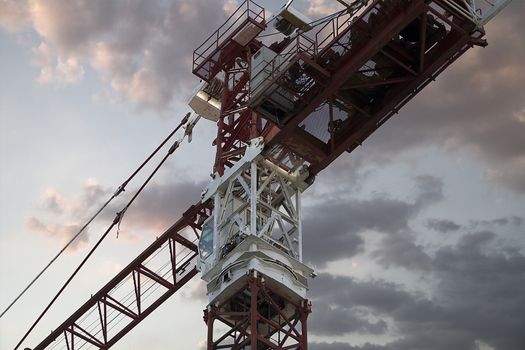 Industrial red crane, sunset background, construction and works