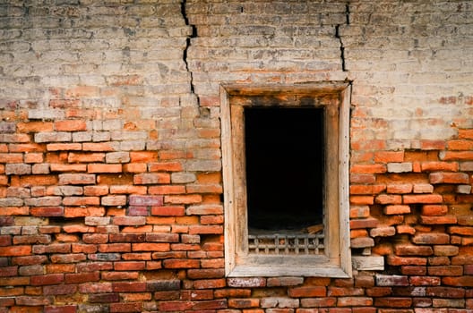 Detail of old weathered textured brick wall and window