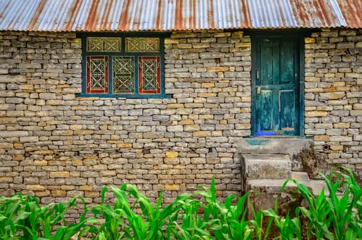 Detail of old brick house wall with entrance door and window