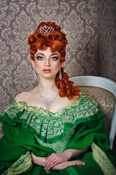 Attractive young girl in green gown and red wig