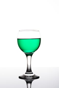 Classy colrfull backlit  glass with green drink and reflection