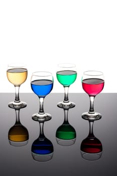 red, green, yellow and blue backlit drinks with reflection