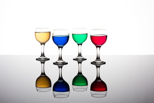 red, green, yellow and blue backlit drinks with reflection