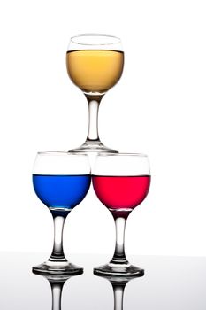 red, yellow and blue backlit drinks with reflection