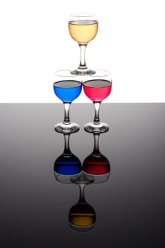 red, yellow and blue backlit drinks with reflection