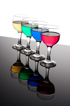 red, green, yellow and blue backlit drinks with reflection