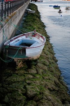 Low tide in an Spanish river with a boat on the rocks