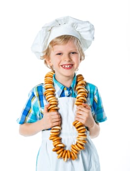 Portrait of Little Cook Boy With A Bagels. Isolated on white background.