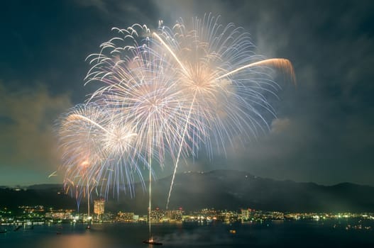 Fireworks exploding in a triangular fashion after being launched from a ship in lake Biwa