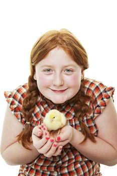 A 10 year old farm girl holding a fluffy, newborn chick on white background.