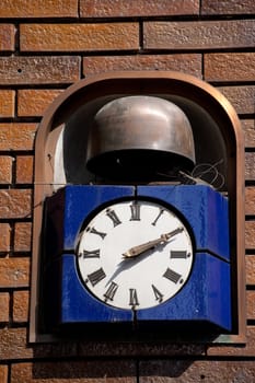 Retro clock hanging on brick wall