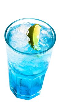 glass of blue cocktail with lime on white background