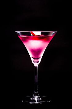 Cosmopolitan cocktail with rose in top of a black background