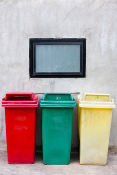 Red green and yellow recycle bin on wall