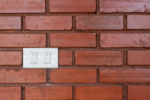 Light switch on red brick wall