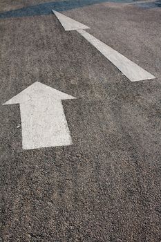 Two forwarded big white arrow on the road