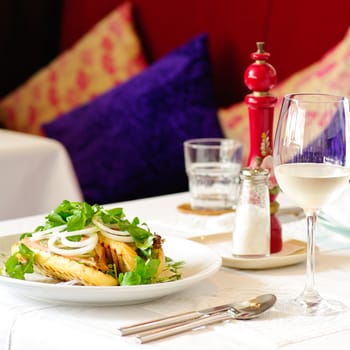 Fine restaurant dinner table place setting: napkin, wineglass