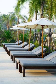 Sunbed beside swimming pool , Thailand