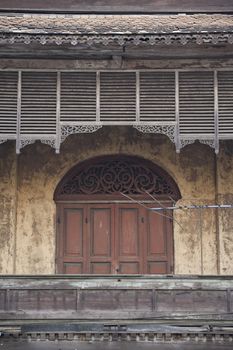 Ancient wooden window with concrete wall in natural rural environment