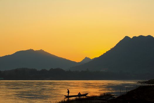 Laos fisherman at river  on sunset