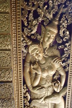 golden figure in a buddhist temple in luang prabang in laos