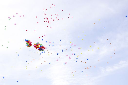 Lots of colorful balloons on the sky background