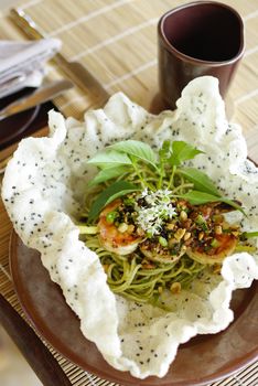plate of green spaghetti broccoli pesto and prawn ready for serve