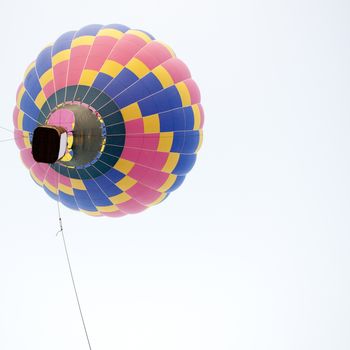 Silhouette hot air balloon landing with many people