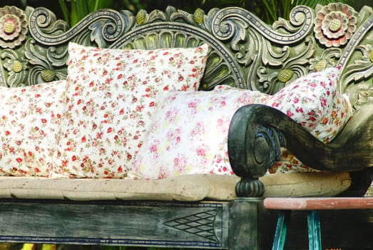 close up picture of many pillows on a wooden sofa
