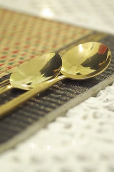 close up gold spoon on dining table restaurant