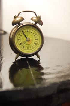 Vintage clock on wood table