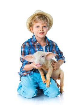 Little farmer. Cute boy with pig. Isolated on white background.