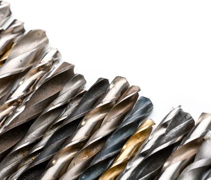 Various used twist drill bits in a row