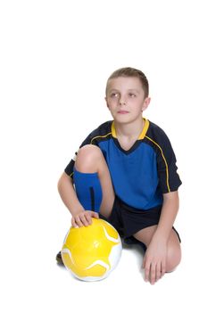 Ten year old boy with a soccer ball isolated on white background.