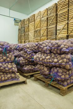 close up view on bags of potato in storage house