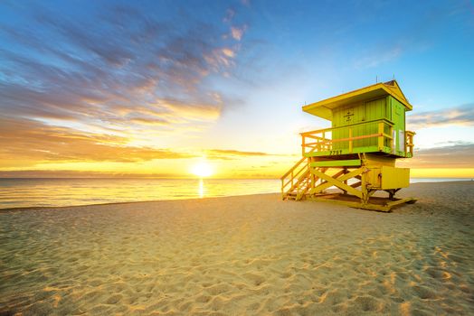 Miami South Beach sunrise with lifeguard tower and coastline with colorful cloud and blue sky. 