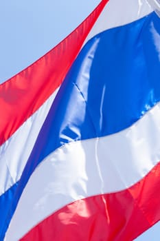 The Thai flag is waved pennants flutter. Behind the bright sky.