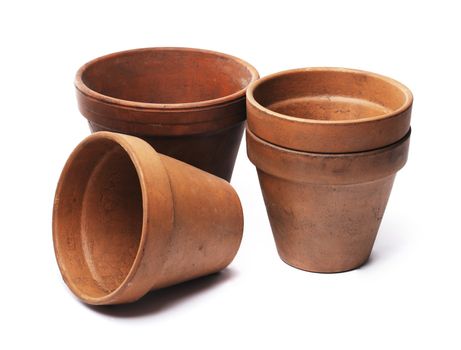Old used flower pots made of clay, isolated on white with natural shadows.