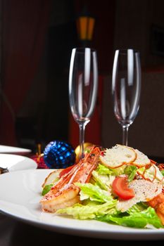 Tasty shrimp salad with vegetables on christmas table