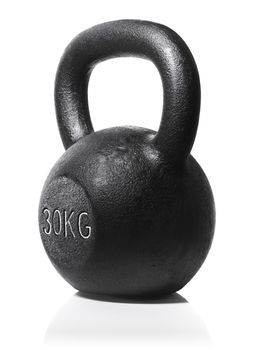 A rough and tough heavy 30 kg 66 lbs cast iron kettlebell isolated on white with natural reflection.