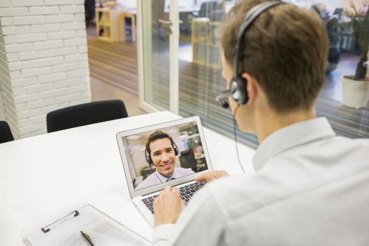 Male calling computer desk video phone