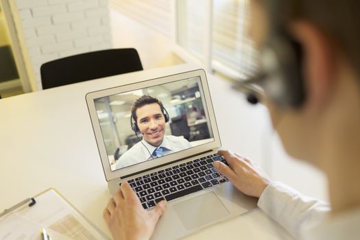 Male calling computer desk video phone