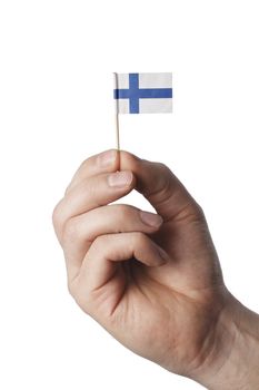 Hand holding tiny flag of Finland