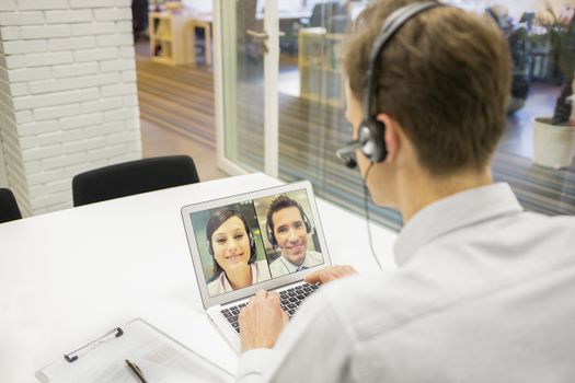 Male calling computer desk video phone