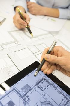 Business team desk architect man woman digital tablet blueprint construction