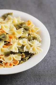 Cooked tricolore farfalle pasta on plate
