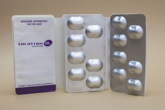 Open medicine packet labelled Solution 20 mg opened at one end to display a blister pack of tablets