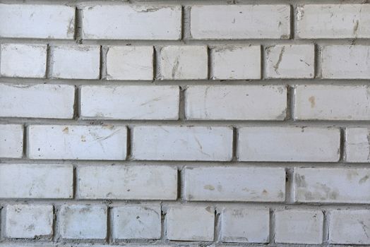 White brick wall. Concrete, cement and dirt